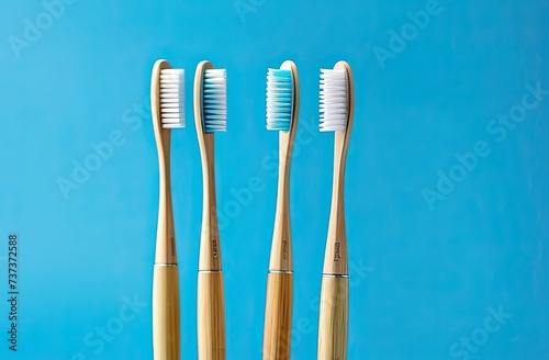 Some eco friendly natural bamboo toothbrushes on blue background. Health care  copy space. Zero waste concept.