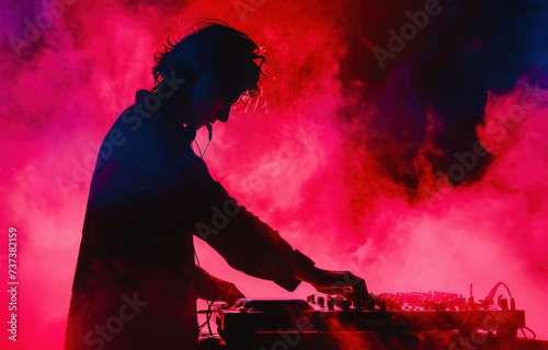 a silhouette of the dj playing at a party