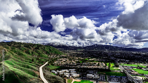 Aerial view of Yucaipa, California after a winter storm with snow covered San Bernardino Mountains, Crafton Hills, Chapman Heights and Yucaipa Valley  Golf Course
