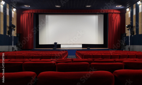 empty cinema auditorium with red chairs