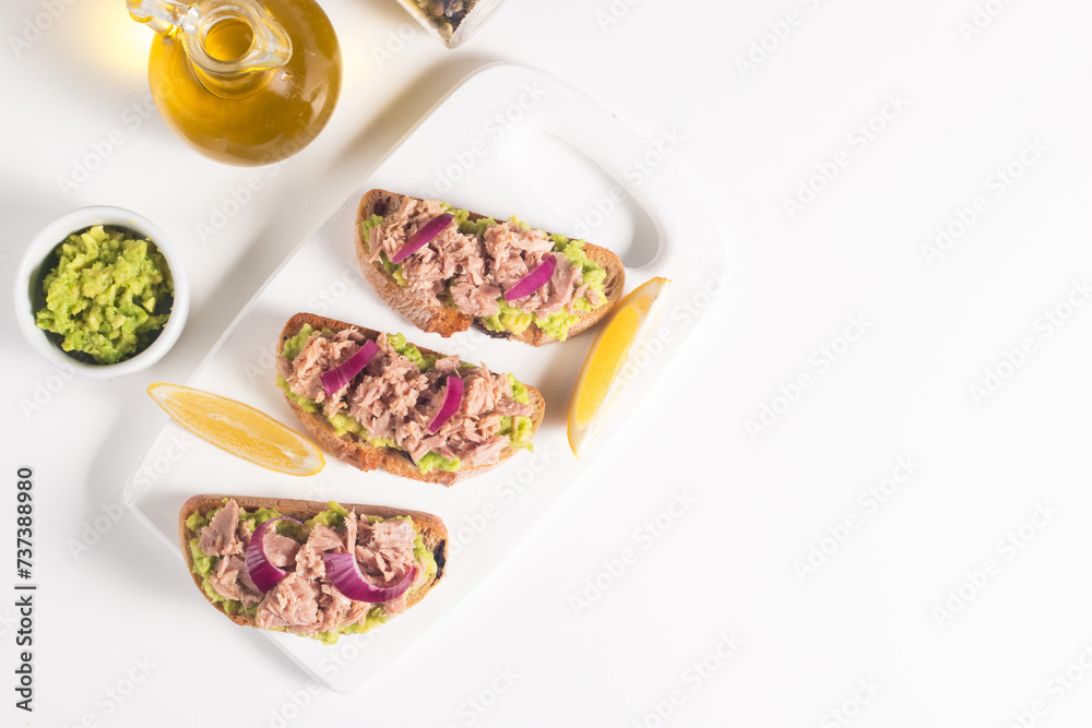 Toast with Canned Tuna. Fish open sandwich with avocado, red onion and lemon. Toast with Canned Tuna. Fish open sandwich with avocado, red onion and lemon.
