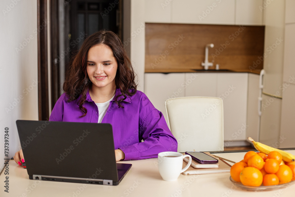 Smiling student studying remotely with laptop. Workspace. Smiling student studying remotely with laptop. Workspace.