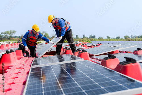 Wallpaper Mural Male workers repair Floating solar panels on water lake. Engineers construct on site Floating solar panels at sun light. clean energy for future living. Industrial Renewable energy of green power. Torontodigital.ca