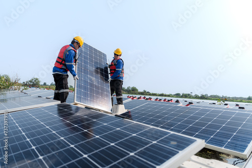 Wallpaper Mural Photovoltaic engineers work on floating photovoltaics. workers Inspect and repair the solar panel equipment floating on water. Engineer working setup Floating solar panels Platform system on the lake. Torontodigital.ca