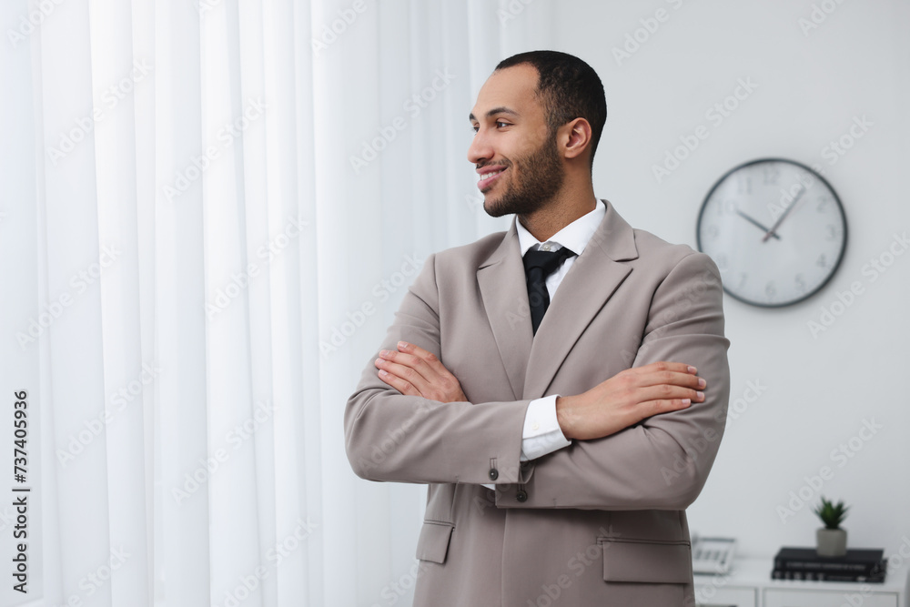 Portrait of smiling young man in office, space for text. Lawyer, businessman, accountant or manager Portrait of smiling young man in office, space for text. Lawyer, businessman, accountant or manager
