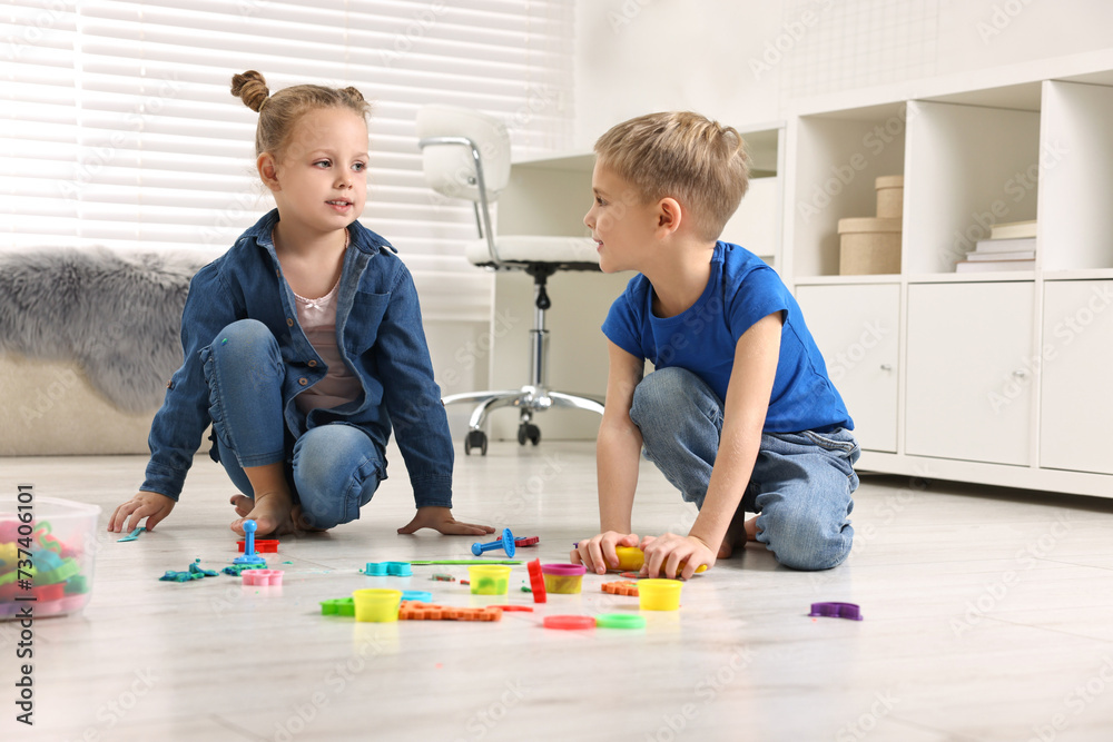 Cute little children playing on warm floor at home. Heating system Cute little children playing on warm floor at home. Heating system