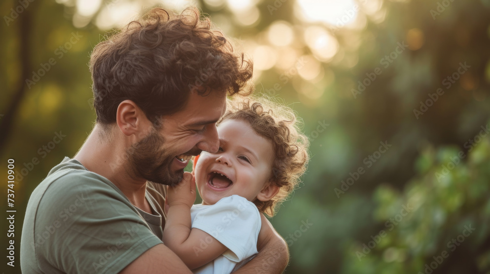joyous moment between a father and his young child, both with curly hair, smiling and laughing together in a close, loving embrace