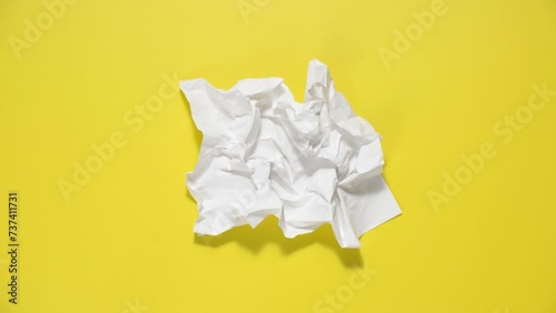 Stop motion animation of crumpled paper, stop motion animation 4k, on a yellow background. photo