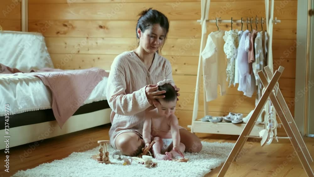 Soft light bathes a nurturing scene, where a mother styles her baby s ...