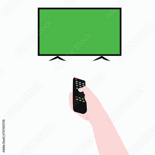 hand holds remote control and points at television with green screen