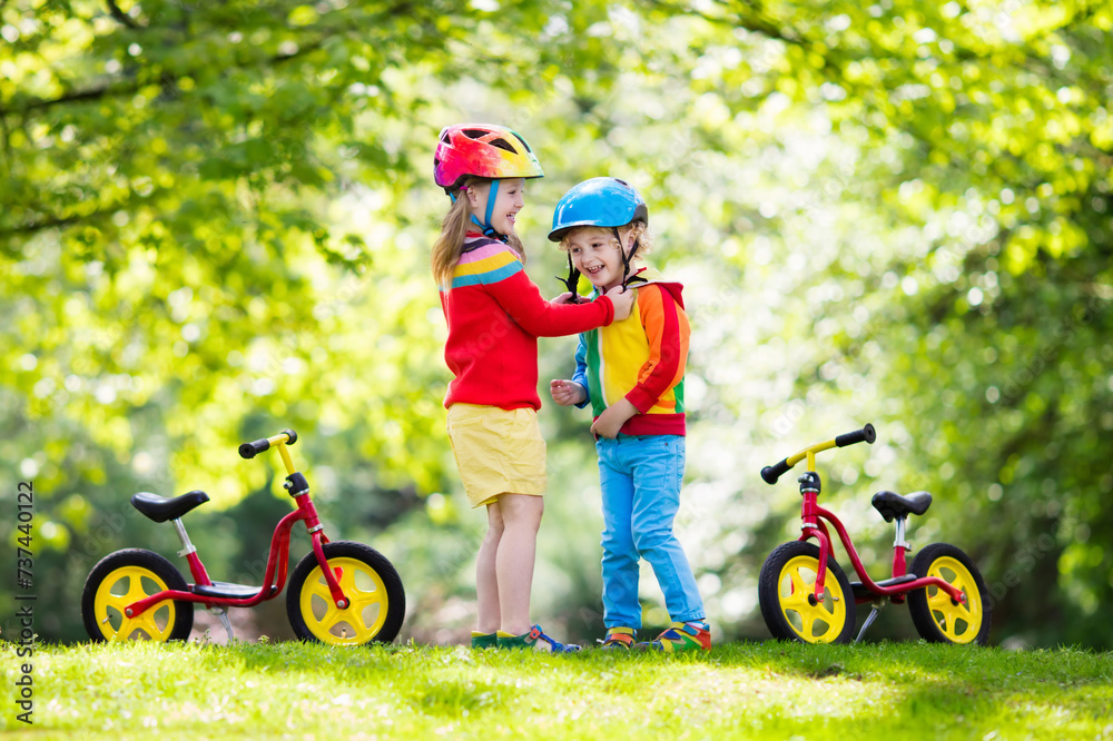 Kids ride balance bike in park Kids ride balance bike in park