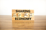 Sharing economy symbol. Concept words Sharing economy on beautiful wooden blocks. Beautiful wooden table white background. House model. Business sharing economy concept. Copy space.