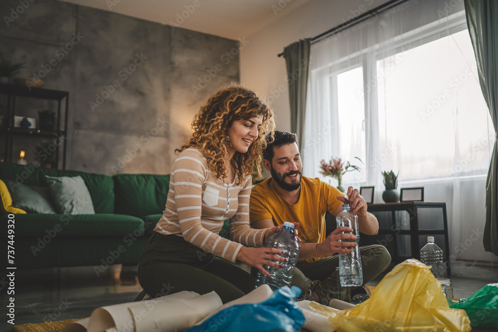 husband and wife recycle at home sorting waste plastic paper and glass husband and wife recycle at home sorting waste plastic paper and glass