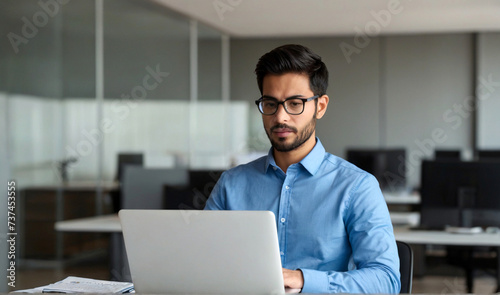 Busy professional business man company employee, young male worker software developer, latin businessman typing on computer technology using laptop searching on web working at office workplace desk