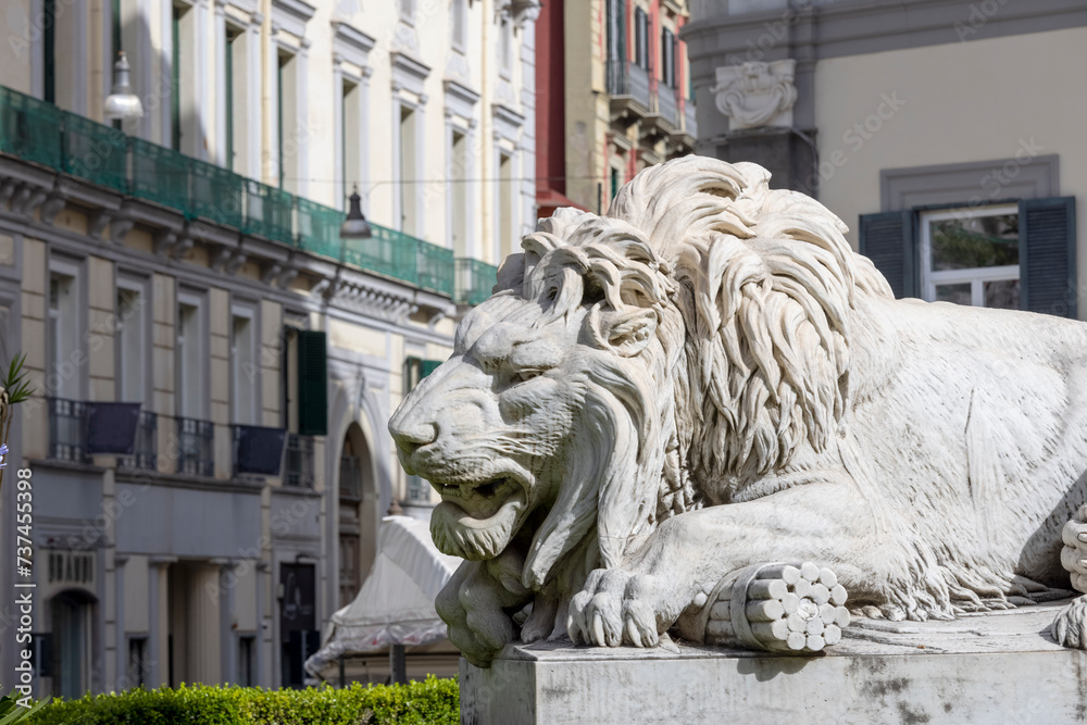 Stone lion statue at the base of the Monument to the Martyrs on Piazza dei Martiri, Naples, Italy