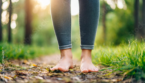 Barefoot woman standing outdoors, symbolizing connection to nature and grounding photo