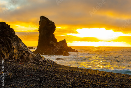 Sunset over the volcanic lava formations of Djupalonssandur beach, Iceland