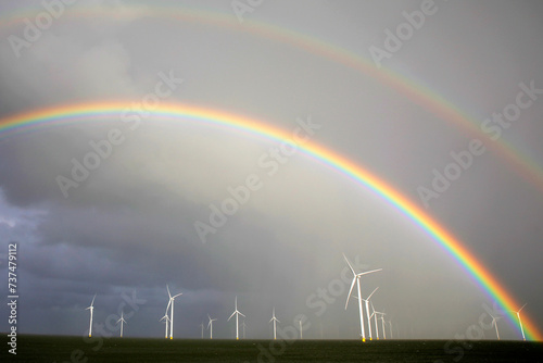 Rainbow above a offshore windpark, Breezanddijk, Holland photo