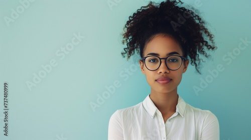 Young professional woman with curly hair wearing glasses photo