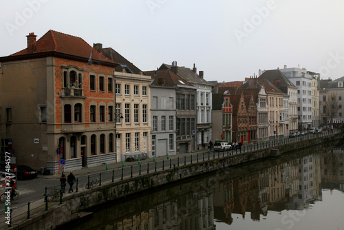 old colorful traditional houses along the canal and boats in Ghent, Belgium