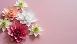 origami paper flowers on pink background with copy space minimal concept