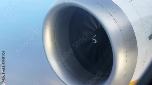 Close-up footage of a plane's engine running while flying over a rural area