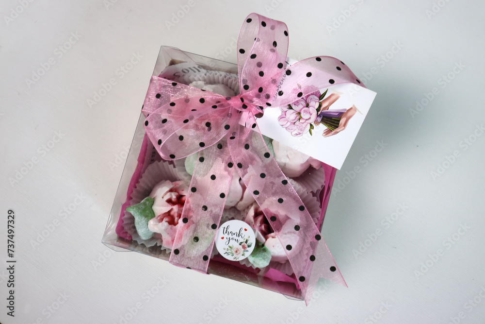 Zephyr flowers. Gift box with pink tulips and bows on a white background. Tulips from marshmallows. Homemade zephyr. Zephyr flowers. Gift box with pink tulips and bows on a white background. Tulips from marshmallows. Homemade zephyr.