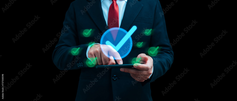 Quality Assurance. business man touching on mobile smart phone with virtual correct sign on dark background, quality control, business finance, guarantee, cybersecurity, digital technology concept - obrazy, fototapety, plakaty 