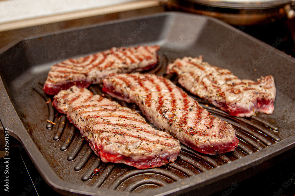 rib eye beef steak fried in a grill pan