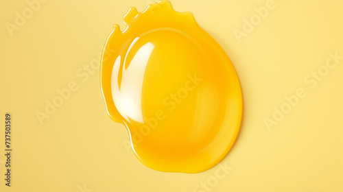 Artificial egg yolk isolated on yellow background photo