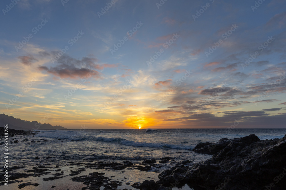 Sunset by the ocean and natural bathing pools of Agaete, Gran Canaria, Spain