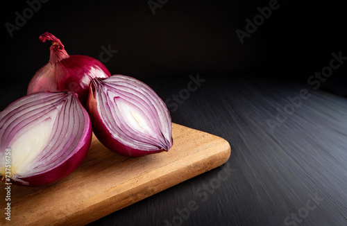 red onion on presentation board and black background