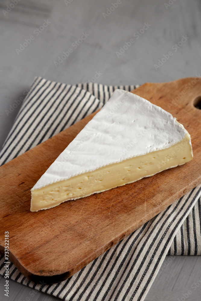Organic Brie Cheese on a wooden board, low angle view. Organic Brie Cheese on a wooden board, low angle view.