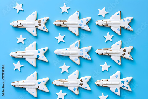 Airplane and stars shaped cookies on blue background. Top view. AI generated