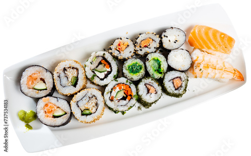 Set of different types of sushi served with sauce soy on board in restaurant. Isolated over white background