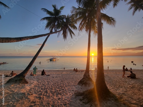 Fototapeta Naklejka Na Ścianę i Meble -  Beautiful palm trees and white sand beach on the island of Siquijor, at sunset - Siquijor, Philippines