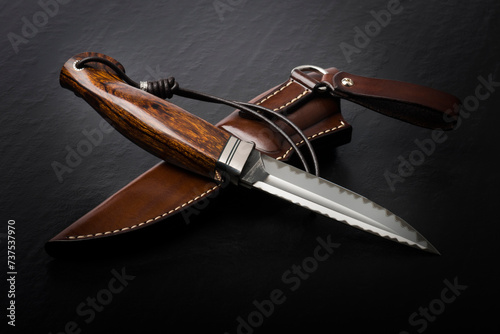 Hunting knife handmade on a black background.
