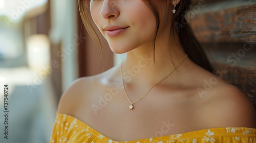 beauty, people and jewelry concept - beautiful young woman wearing shiny diamond pendant photo