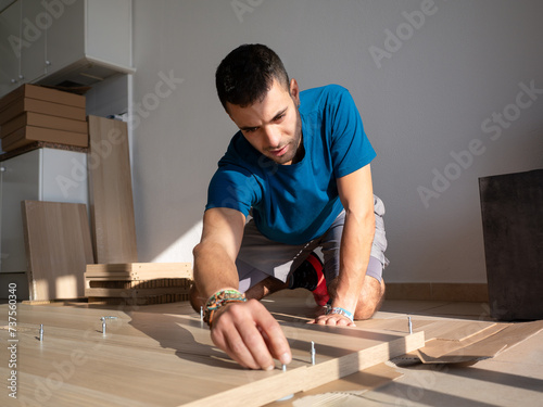 Man Focused on Home Furniture Assembly