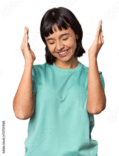 Young Hispanic woman with short black hair in studio joyful laughing a lot. Happiness concept.