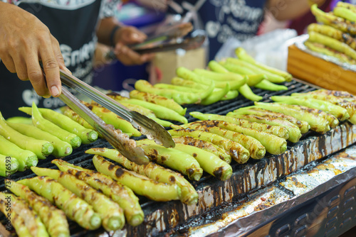 Grilling Fresh Green Chilies at a Street Food Stall