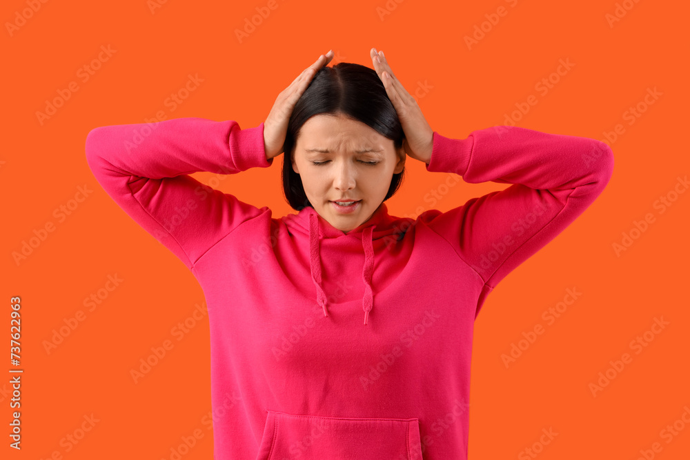 Stressed young woman on orange background Stressed young woman on orange background