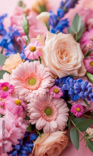 Soft pink and blue spring flowers with a plain blurred pink background.  © Elle Arden 