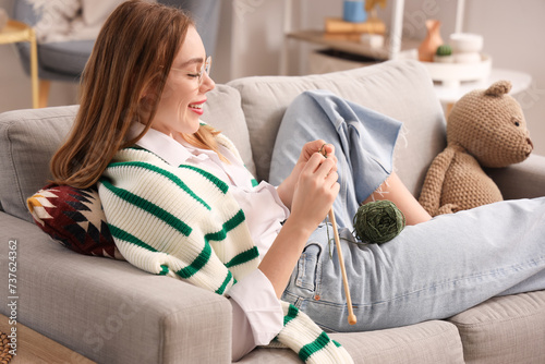 Young woman knitting with n...