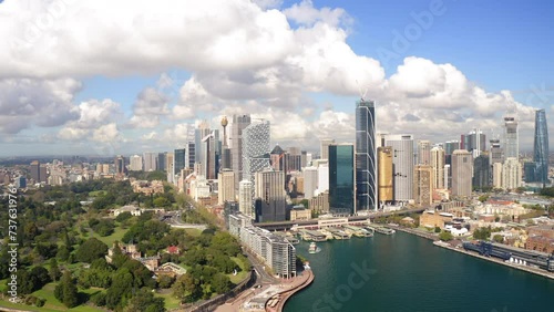 Aerial Shot Of Modern Financial District Against Cloudy Sky, Drone Flying Forward Over Inlet On Sunny Day - Sydney, Australia photo