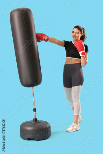 Young woman in boxing glove...