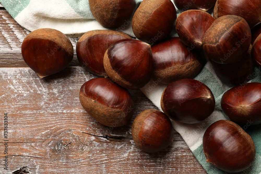 Sweet fresh edible chestnuts on wooden table, top view Sweet fresh edible chestnuts on wooden table, top view