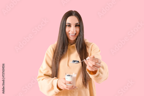 Young woman with tasty yogh...