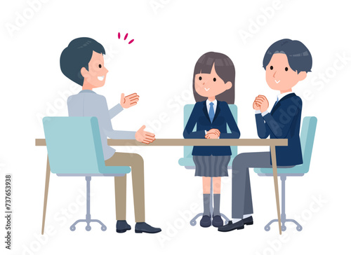 学生2人を相手に話す教師