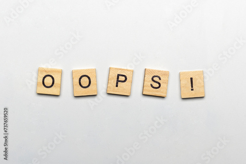 The row of wooden cubes with 'Oops!' text